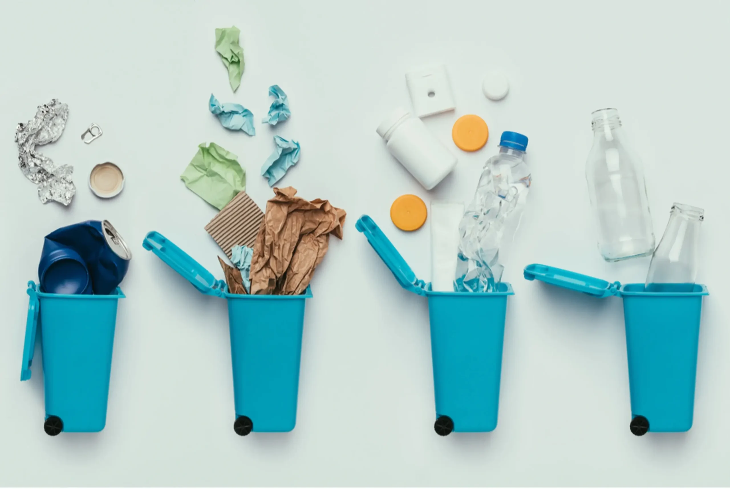 trash being thrown in recyling bins